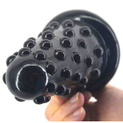 Plug anale nero lucido con foro centrale e texture a sfere
