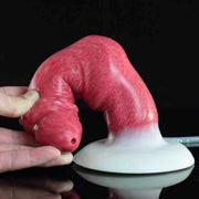 Dildo Bonewolf Damon in silicone rosa flessibile mostrato piegato a mano