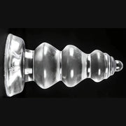 Plug anale trasparente Chikubi a gradini con ventosa base su sfondo nero
