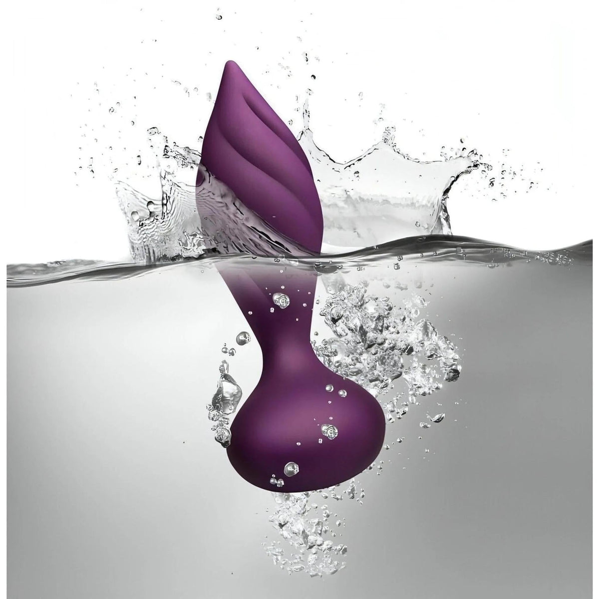 Plug anale Desire viola impermeabile a spirale immerso nell'acqua con spruzzi