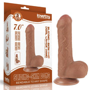 Dildo marrone chiaro accanto confezione Lovetoy sliding skin layer