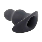 Vista laterale plug anale tunnel in silicone nero opaco apertura posteriore
