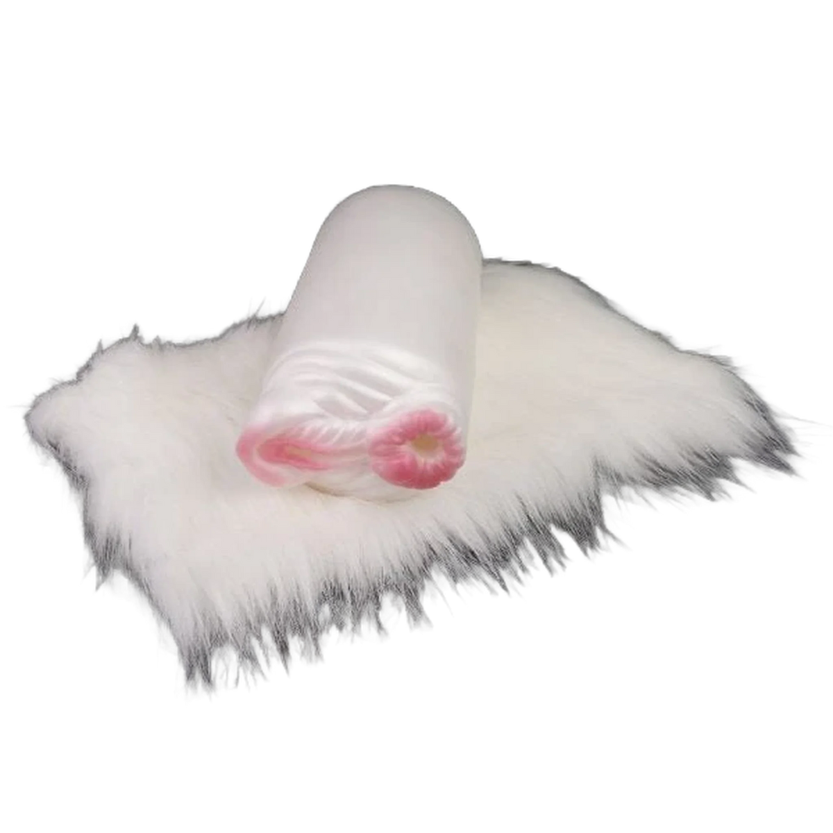 Giocattolo orizzontale interno rosa visibile su superficie pelosa bianca