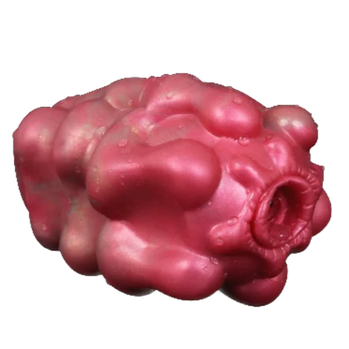 Masturbatore Jagged Bones rosa in silicone liquido con forma organica e apertura ondulata