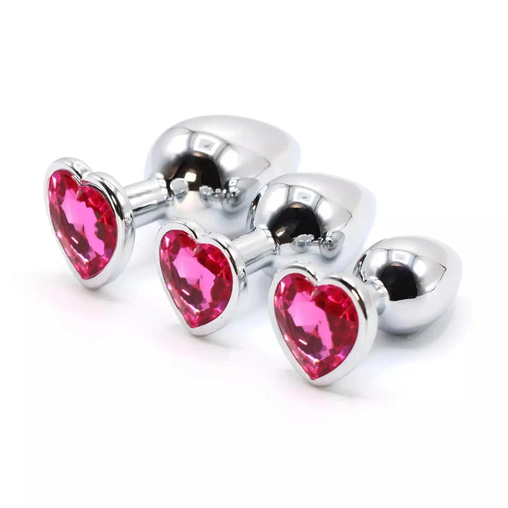 Plug anale in acciaio con cuore Swarovski fucsia, tre dimensioni diverse