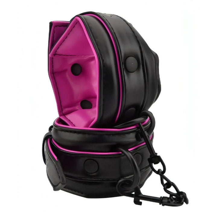 Polsiere BDSM nere e fucsia in pelle con imbottitura morbida e catena
