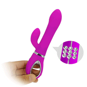 Vibratore coniglio viola acceso tenuto in mano con griglia di sfere metalliche per stimolazione
