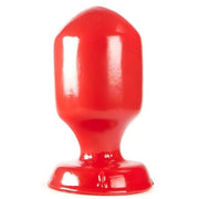 Plug anale rosso lucido forma cuneo vista frontale centrata