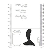 Confronto dimensioni stimolatore prostatico nero in silicone con scala metrica e oggetti comuni