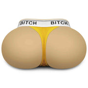 Masturbatore realistico glutei beige con perizoma giallo scritta Bitch su sfondo bianco